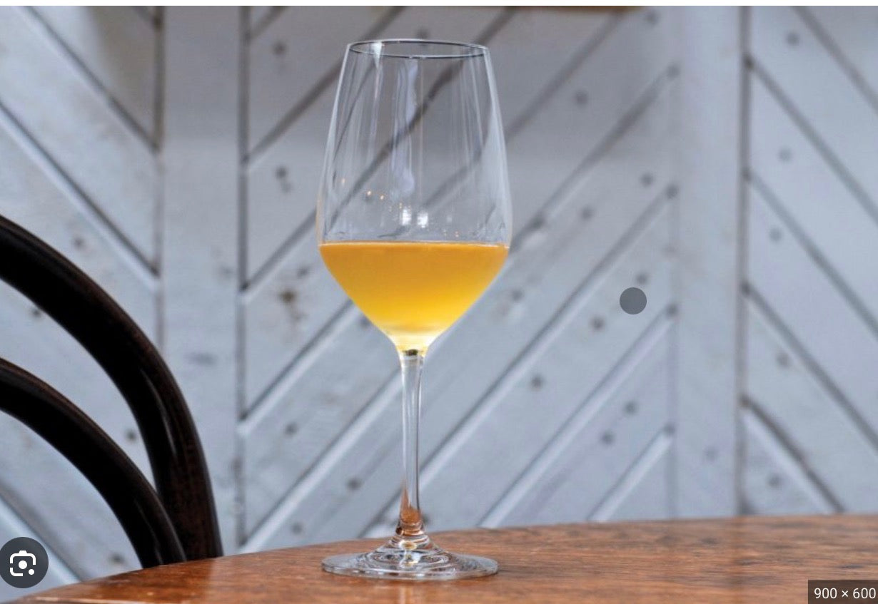 glass of natural wine on wood table